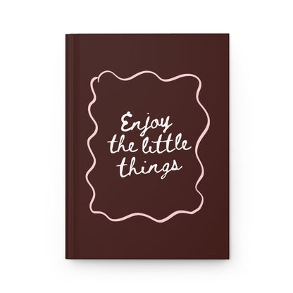 brown aesthetic journal with “enjoy the little things” handwritten quote