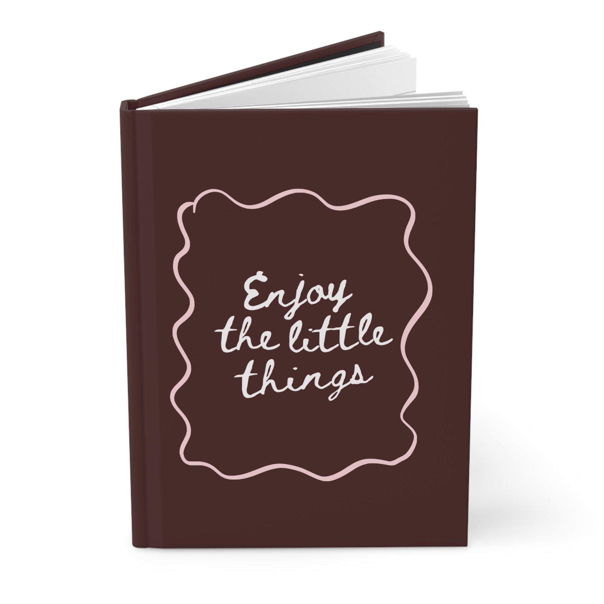 brown aesthetic journal with “enjoy the little things” handwritten quote