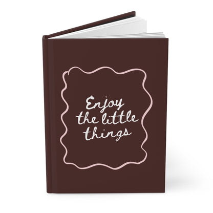 brown aesthetic journal with “enjoy the little things” handwritten quote